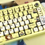 Gallery of Hirasawa Yui K-On! RGB translucent pudding keycaps set, showcasing vibrant anime art and four-sided glow from various angles on a mechanical keyboard.