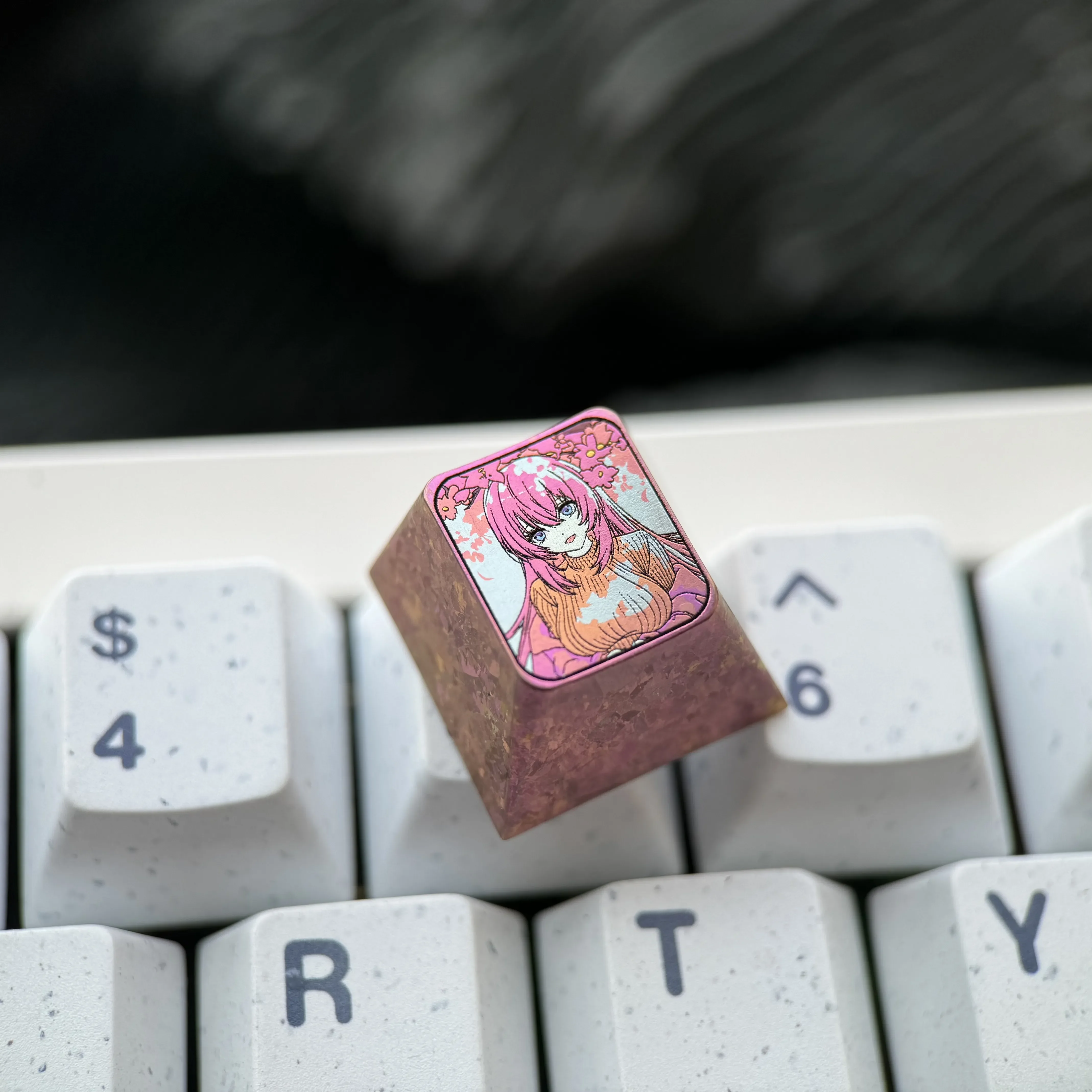 Multiple angles of the exclusive Ichinose Honami titanium keycap, highlighting the vibrant anime art on its lustrous metallic canvas for mechanical keyboard.