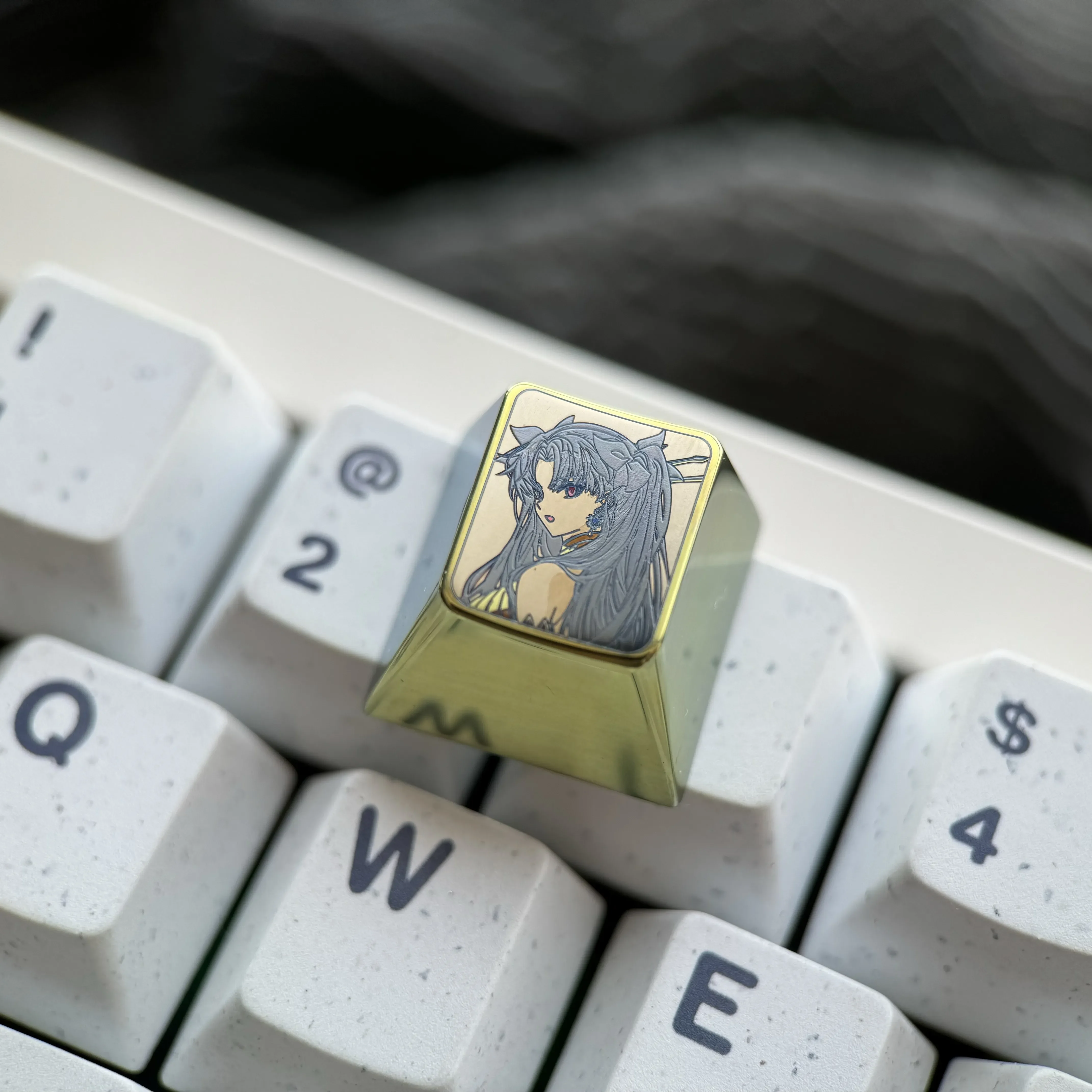 This product gallery image features the vibrant titanium Ishtar artisan keycap, showcasing its celestial anime goddess design from a unique angle.