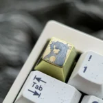 Views of the vibrant titanium Ishtar artisan keycap, highlighting its celestial anime goddess design, intricate details, and premium finish.