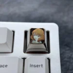 Exquisite Kumiko Oumae anime keycap, a premium titanium ESC keycap with vibrant character art, polished colors, and subtle icy accents.
