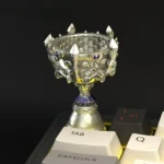 Multiple views of the Iconic LoL S15 Trophy Keycap. This detailed 3D collectible, with its brilliant metallic-gold finish, embodies League of Legends.