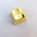 A luxurious gold ESC keycap, showcasing intricate laser engraving and its substantial, premium feel. Elevate your keyboard.