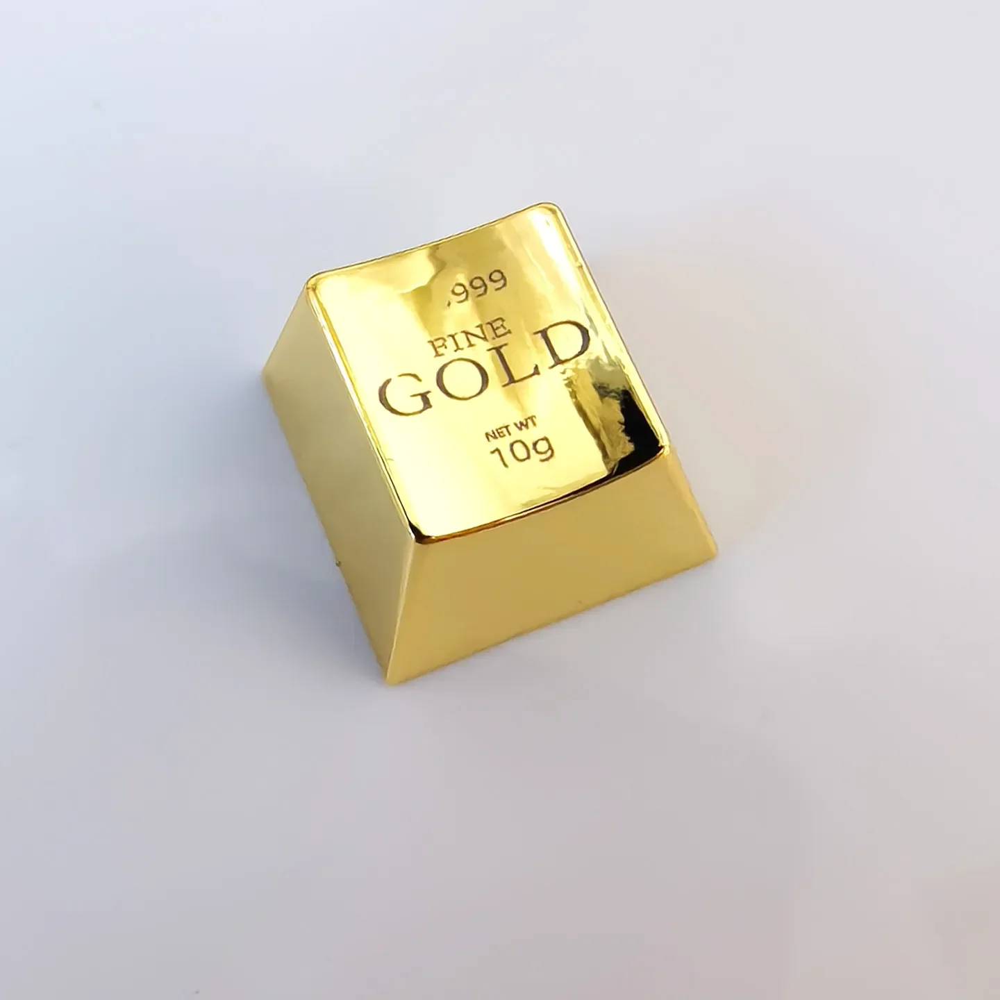 A luxurious gold ESC keycap, showcasing intricate laser engraving and its substantial, premium feel. Elevate your keyboard.