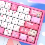 A playful collection of Mahiro Oyama side-lit PBT anime keycaps set from various angles, highlighting vibrant artwork and captivating backlit legends.