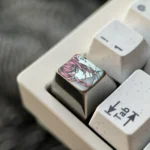 Multiple views of the exquisite hand-carved Makima titanium keycap, showcasing its elegant line art and premium craftsmanship from various angles.