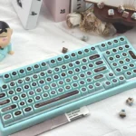 Ainbell Base99 tri-mode hot-swappable mechanical keyboard featuring a charming mint chocolate color palette and elegant, clean design.