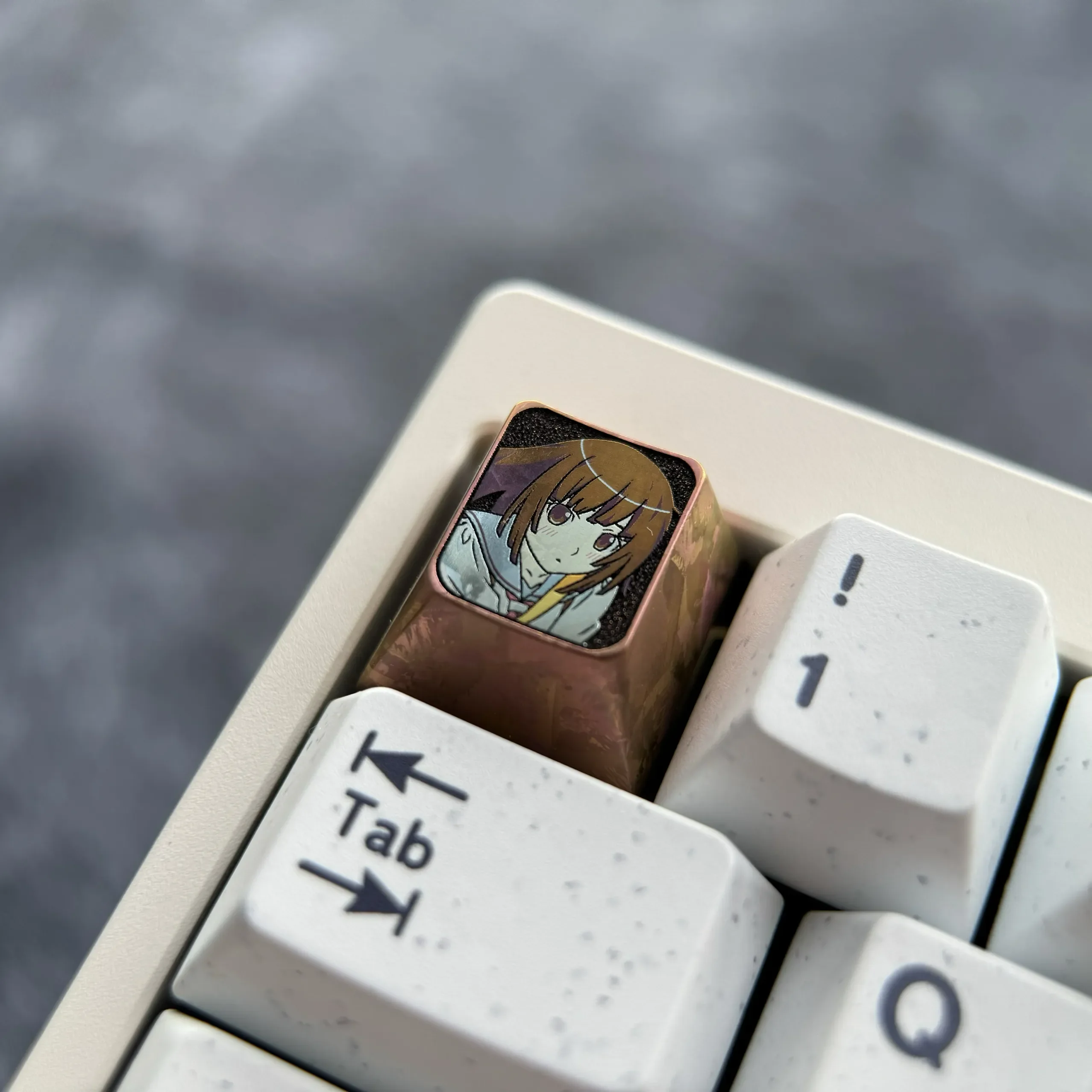 Multiple views of the artistic Sengoku Nadeko titanium keycap, highlighting its iconic character, premium finish, and unique chocolate coloring.