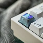 Close-up views of the Ninja Gaiden: Ryu Hayabusa Keycap in ice crystal grey, revealing its sleek metallic finish and premium setup.