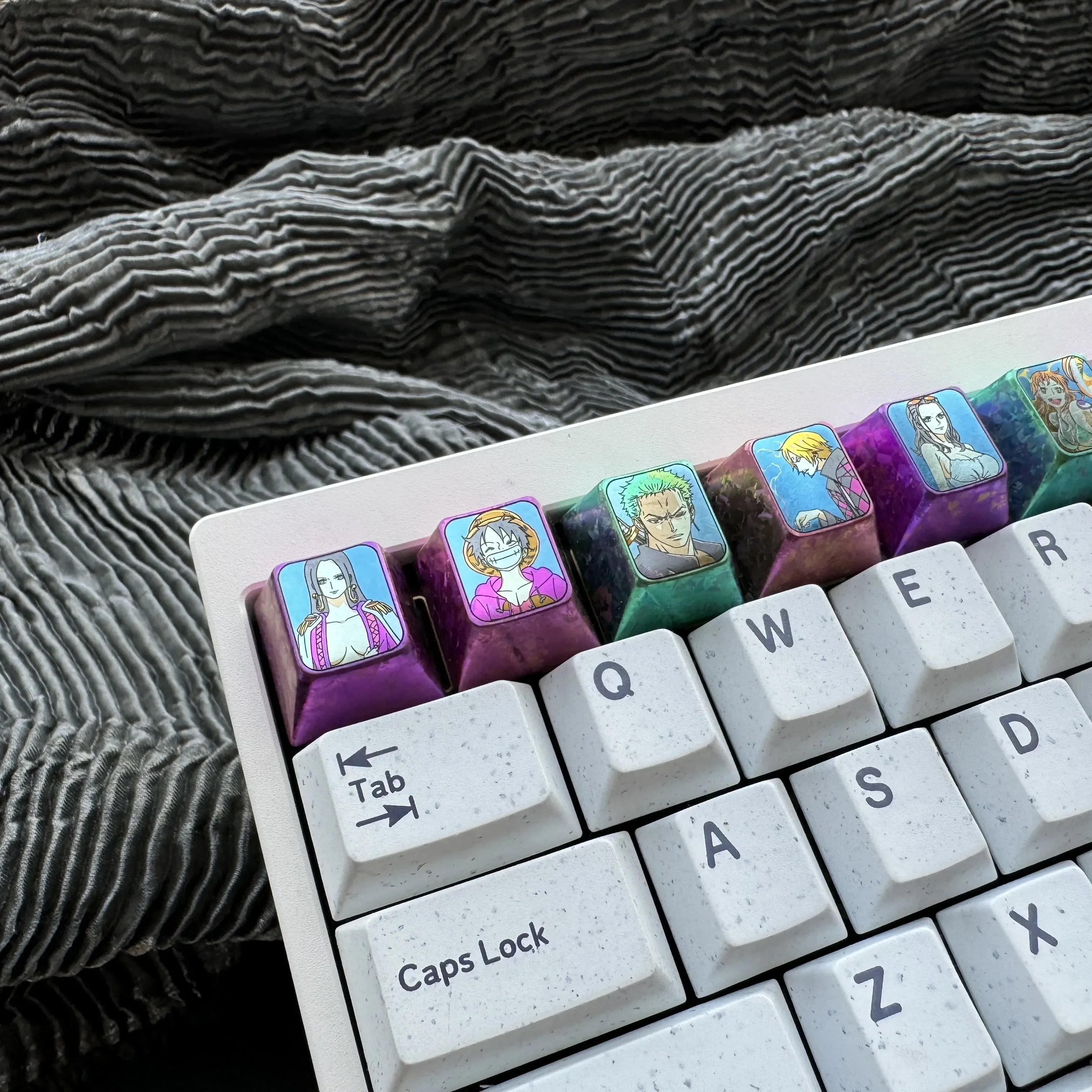 Premium Titanium ONE PIECE keycap for mechanical keyboards, showcasing intricate metal craftsmanship and vibrant One Piece character design.