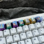 Explore the Premium Titanium ONE PIECE Artisan Keycap from various angles, highlighting its intricate design and vibrant anime details for mechanical keyboard.