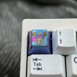 Close-up of the premium Titanium ONE PIECE artisan keycap, highlighting the vibrant One Piece character design and intricate metal craftsmanship.