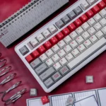 Retro Flooding Keycap Set refreshing PBT dye-sublimated keyboard keycaps in crisp red n and cool white, shown from various angles.