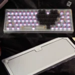 Ainbell Base68 romantic mechanical keyboard in soft pink, featuring charming heart motifs, presented as an artistic gift.