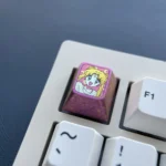 Multiple views of the enchanting red titanium Sailor Moon ESC keycap, highlighting its lustrous finish and iconic anime motifs. A premium custom keyboard design.