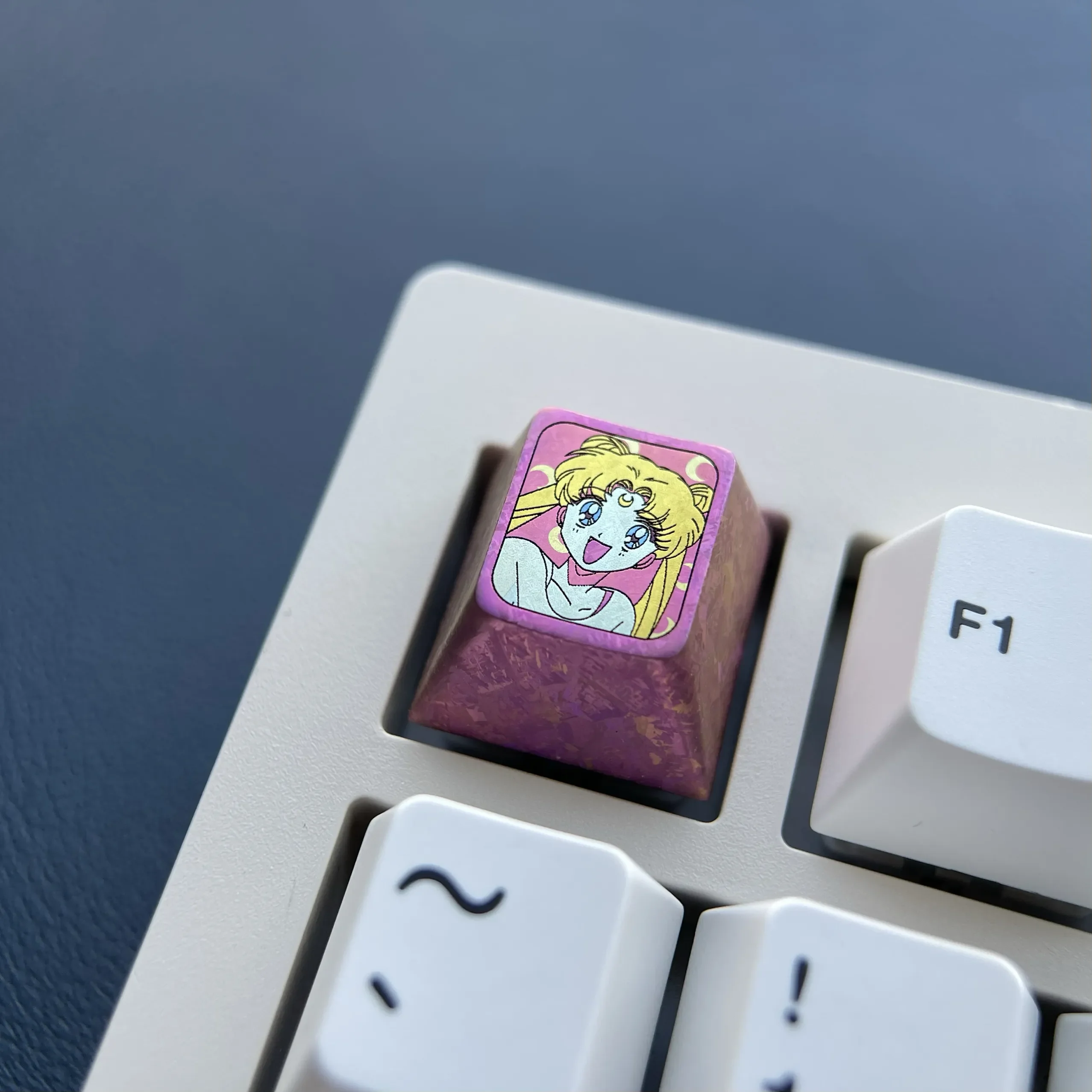 Multiple views of the enchanting red titanium Sailor Moon ESC keycap, highlighting its lustrous finish and iconic anime motifs. A premium custom keyboard design.