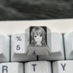 Premium Sakurajima Mai titanium keycap, meticulously engraved with anime art, exhibiting its exquisite metallic finish and artisan craftsmanship.