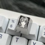 Premium Sakurajima Mai engraved titanium artisan keycap showcased from various angles, highlighting its intricate anime artwork and precise metallic.