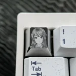 Detailed views of the premium Sakurajima Mai engraved titanium keycap, showcasing its intricate anime art and lustrous metallic finish.