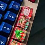 Views of the handcrafted Christmas resin keycap, highlighting its whimsical Santa Claus figure encased in vibrant clear resin. Perfect unique festive design.