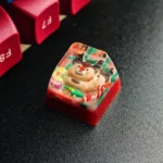 A charming handcrafted Christmas resin keycap, showcasing a whimsical Santa in clear, vibrant resin. A unique festive Christmas artisan keyboard gift.