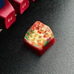 Handcrafted Christmas resin keycap, a close-up showcasing the whimsical festive Santa figure encased in vibrant clear resin. A unique artisan keyboard.