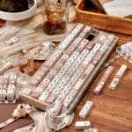 Elegant Siamese cat keycap set in warm coffee tones, showcasing intricate feline motifs. This exquisite dye-sublimated PBT set enhances a cozy