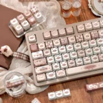 Gallery of elegant Siamese cat keycap set, showcasing various MAO profile PBT dye-sublimation designs with warm coffee tones and intricate feline motifs.