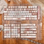 Elegant Siamese cat keycap set showcasing exquisite dye-sublimated PBT with warm coffee tones and intricate feline motifs.