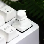 A gallery showcasing the handcrafted Spy x Family Bond Forger artisan keycap from multiple angles, highlighting its charming, detailed resin.