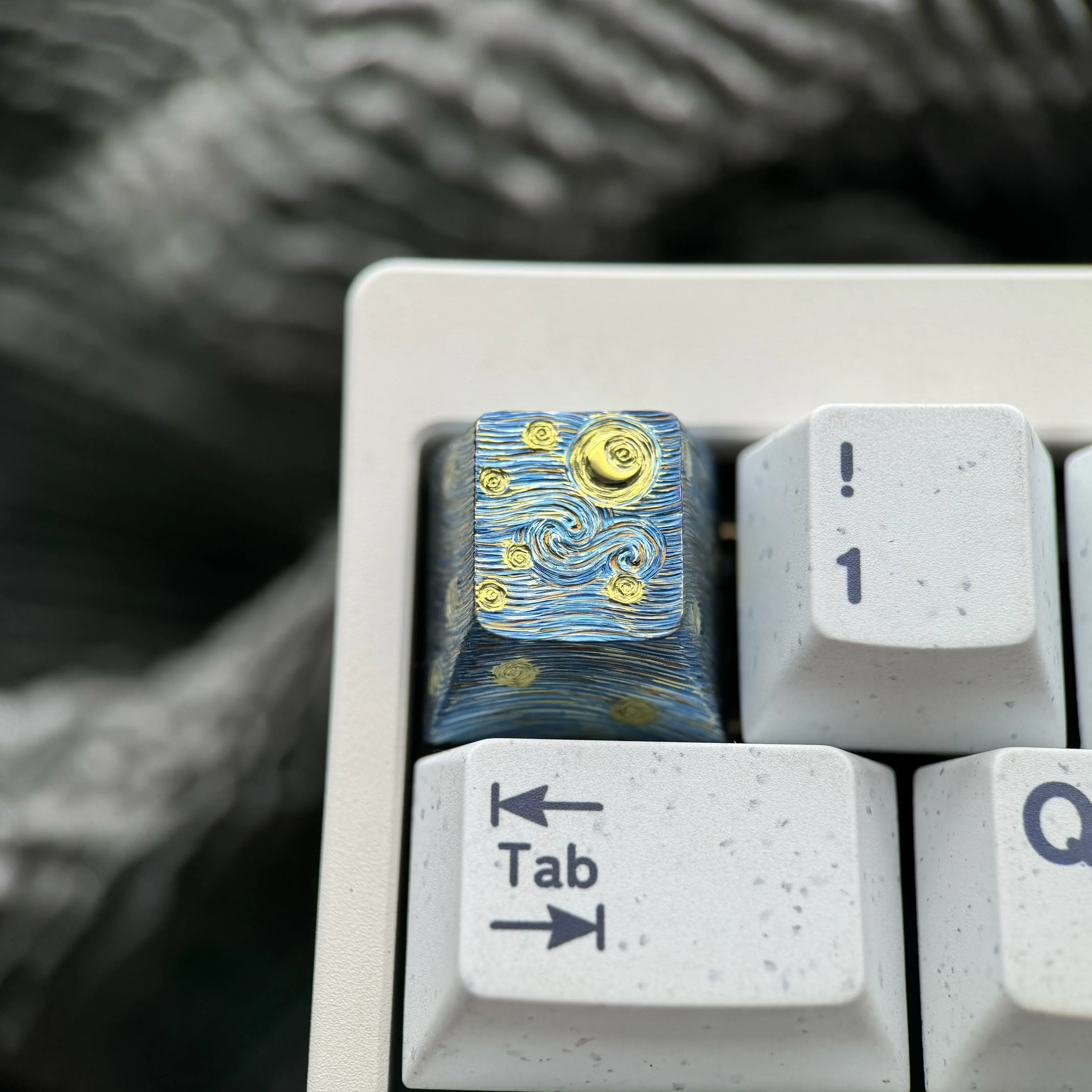 Hand-carved titanium Starry Night keycap. Multiple views highlight Van Gogh celestial landscape, intricate relief, metallic sheen.