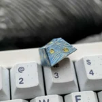 Hand-carved titanium Starry Night keycap gallery. Shows Van Gogh celestial landscape, relief, metallic sheen, all angles.