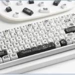 Whimsical Super Cow keycaps set gallery. Durable PBT dye-sub MOA profile full set shown from various angles, highlighting the charming black and white design.