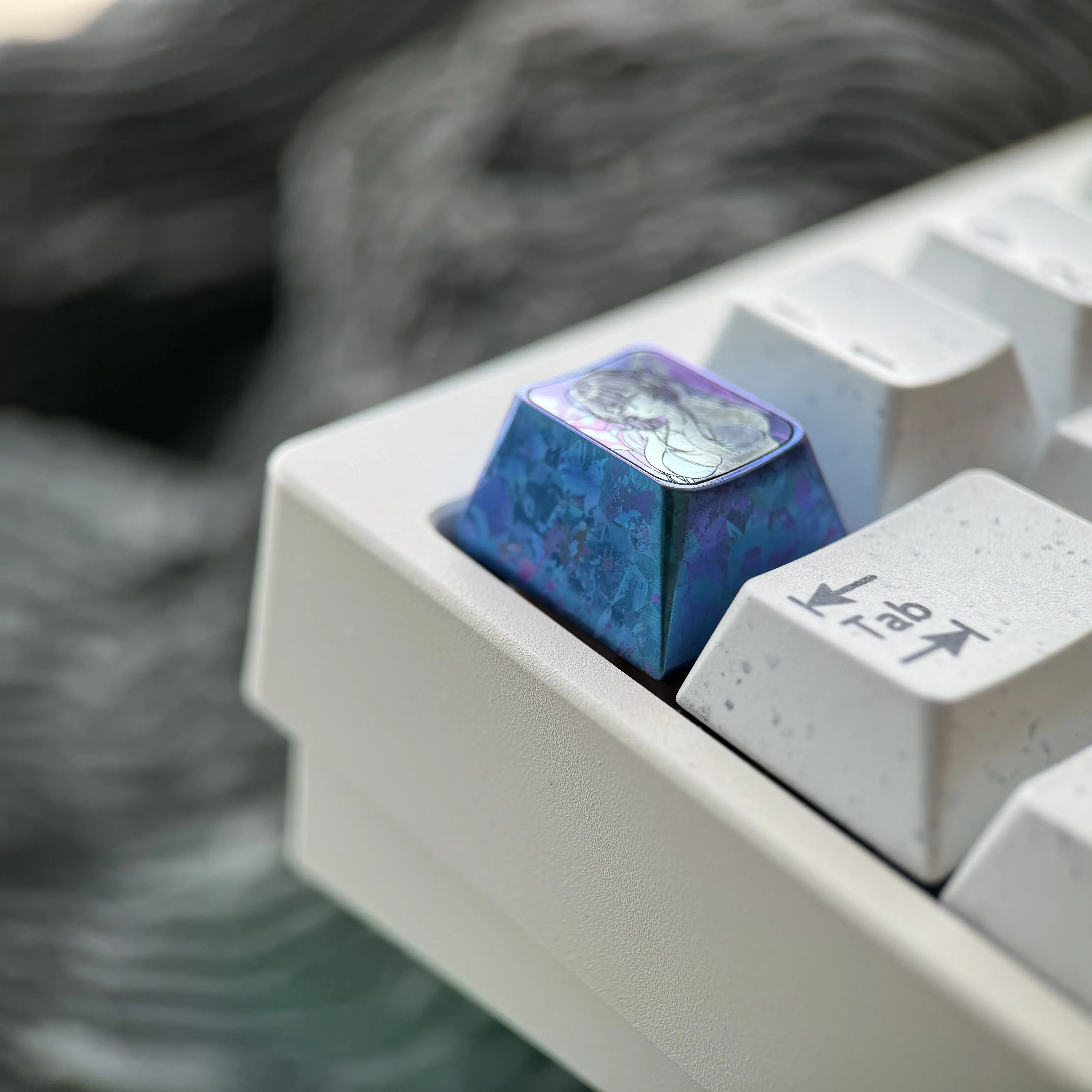 Premium Colored Titanium Azur Lane Taihou keycap, showcasing the intricate character art and icy blue finish from a distinct angle for custom gaming.