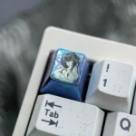 Premium Colored Titanium Azur Lane Taihou gaming keycap showcasing its icy blue metallic finish and intricate character art from various angles.