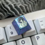 This Azur Lane Taihou Keycap, crafted from Premium Colored Titanium, showcases its intricate design and icy blue finish from various engaging angles.