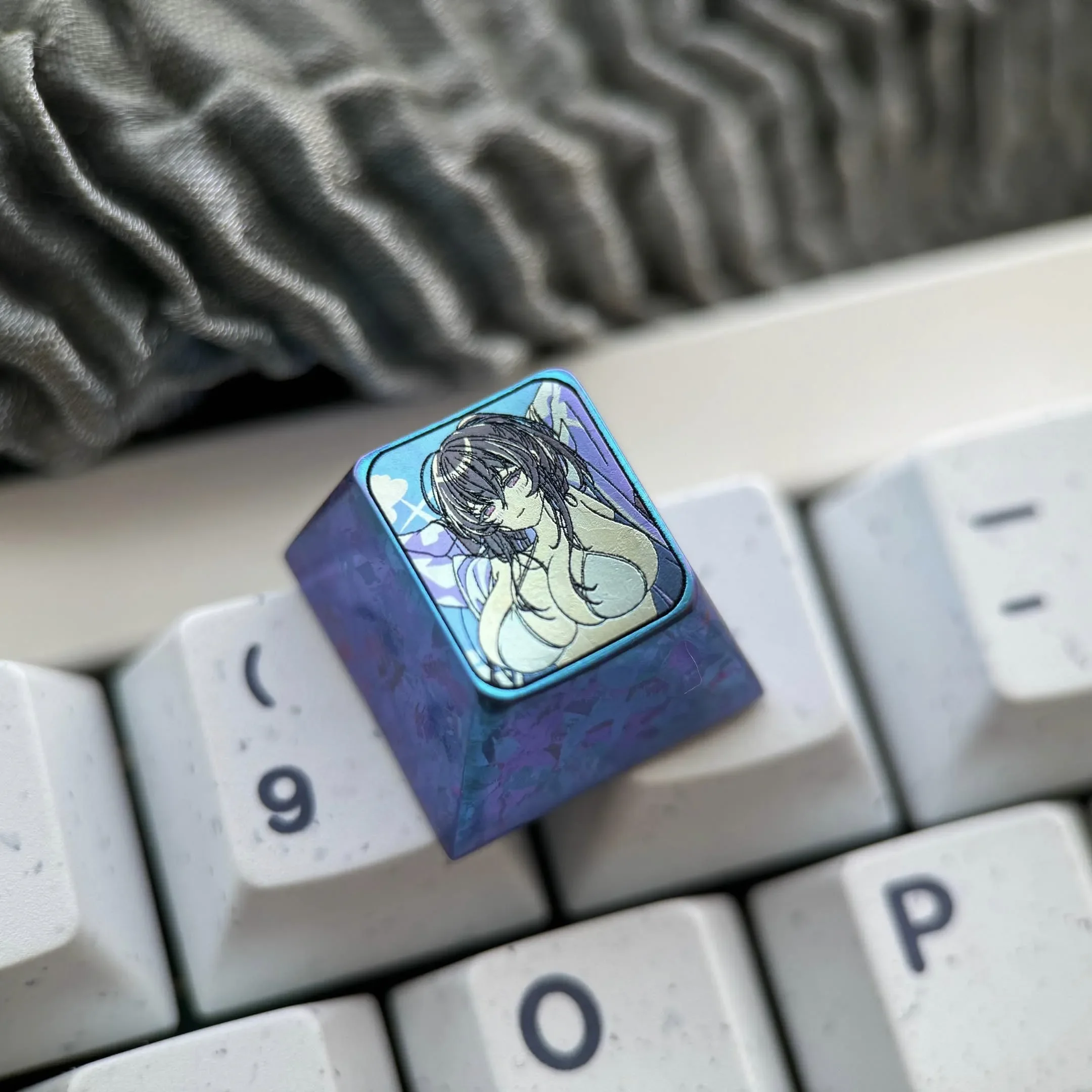 This Azur Lane Taihou Keycap, crafted from Premium Colored Titanium, showcases its intricate design and icy blue finish from various engaging angles.
