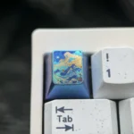 Detailed gallery showcasing the handcrafted titanium artisan keycap, highlighting its serene abstract mountain design and vibrant metallic colors.