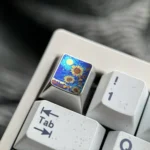 Handcrafted titanium ESC keycap with a vibrant, anime-inspired sunflower blossom, adding an artistic accent to a mechanical keyboard.