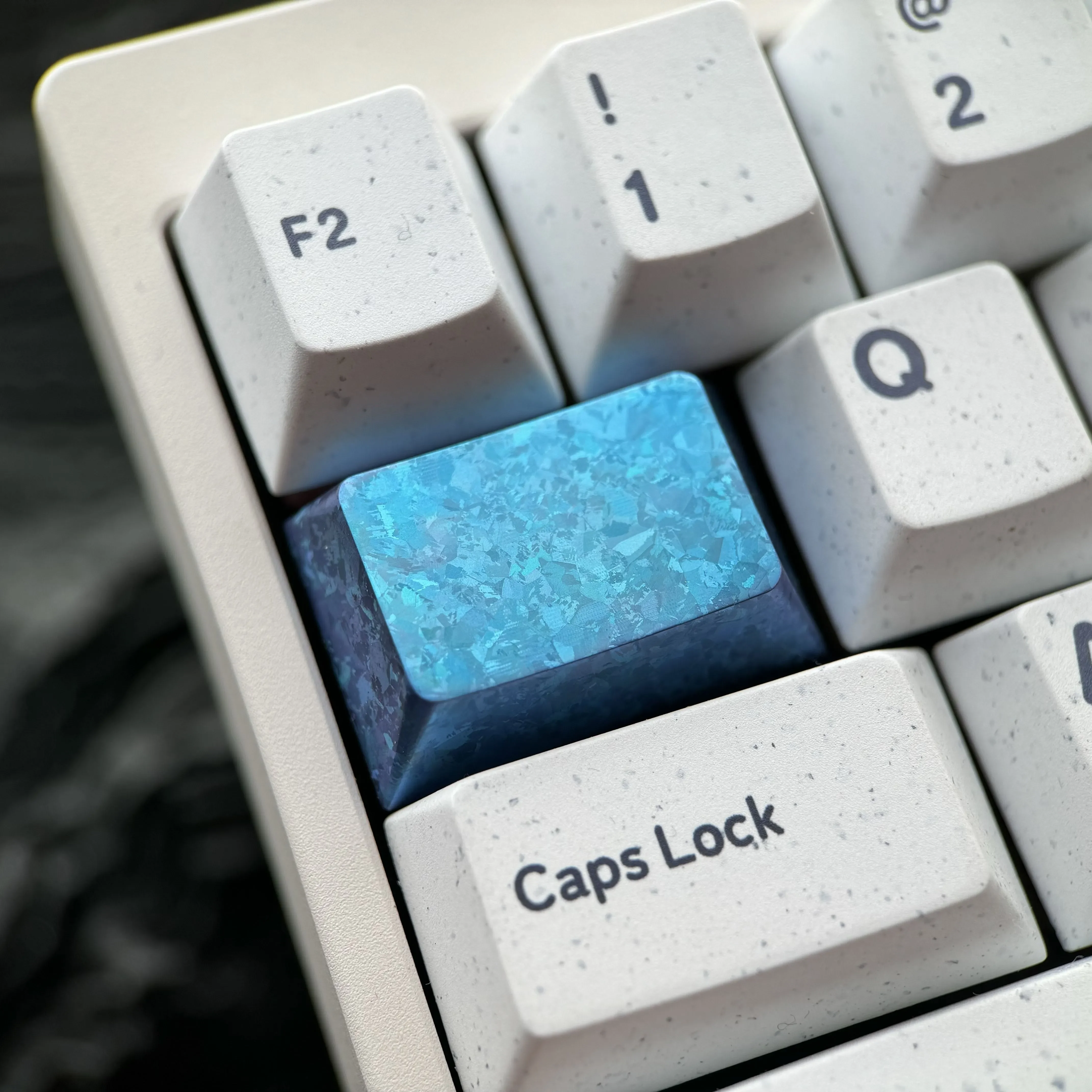 Ice Crystal Titanium Keycap, a premium custom mechanical keycap showcasing its shimmering, jewel-like design and titanium alloy craftsmanship.
