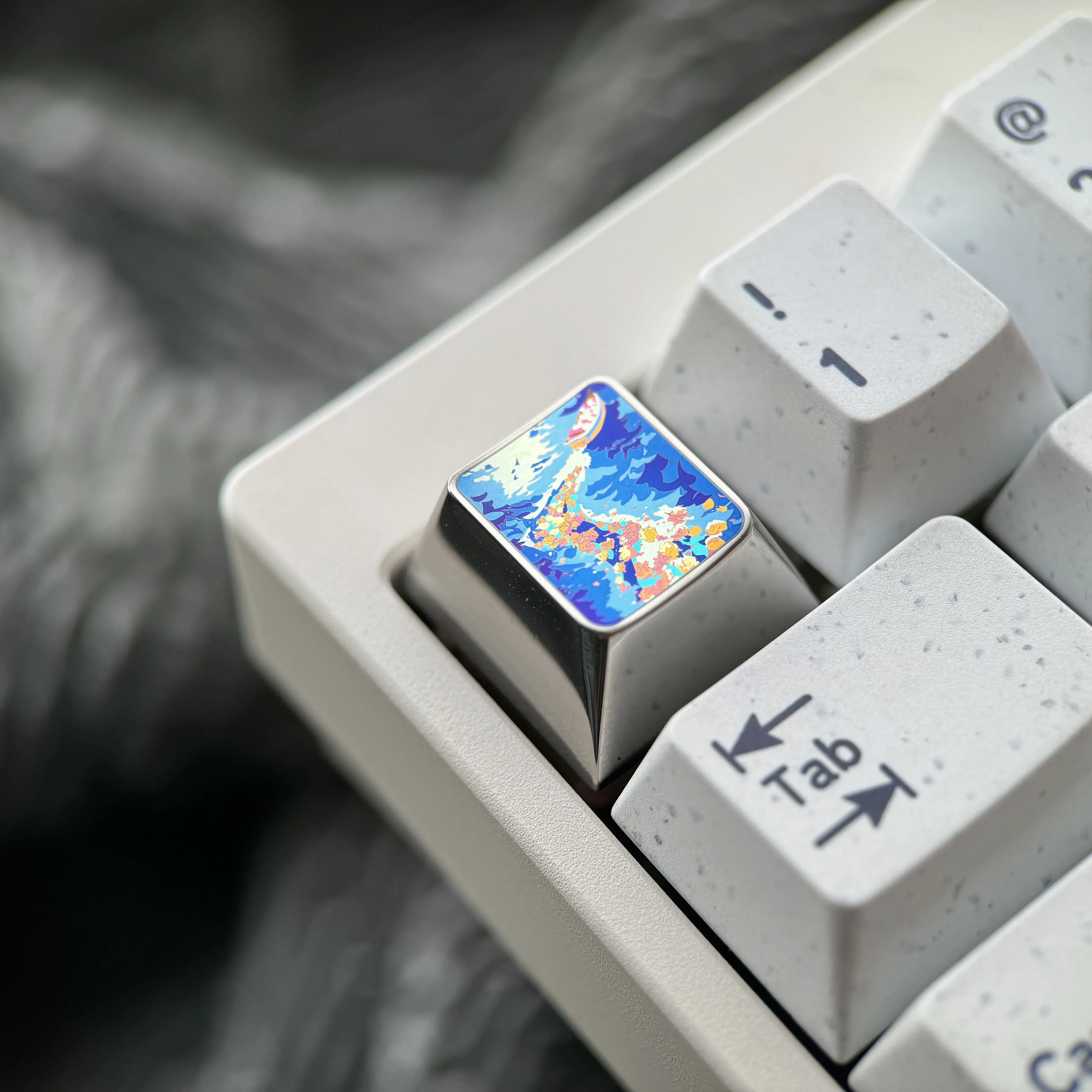Explore the Vibrant Anime Titanium Wave Keycap from various angles, revealing its dynamic ocean wave design, premium titanium finish, and artistic feel.