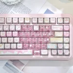 Multiple playful pink transparent heart keycap set with adorable MAO cat designs, displayed from various angles. This 21-key set brings a whimsical touch.