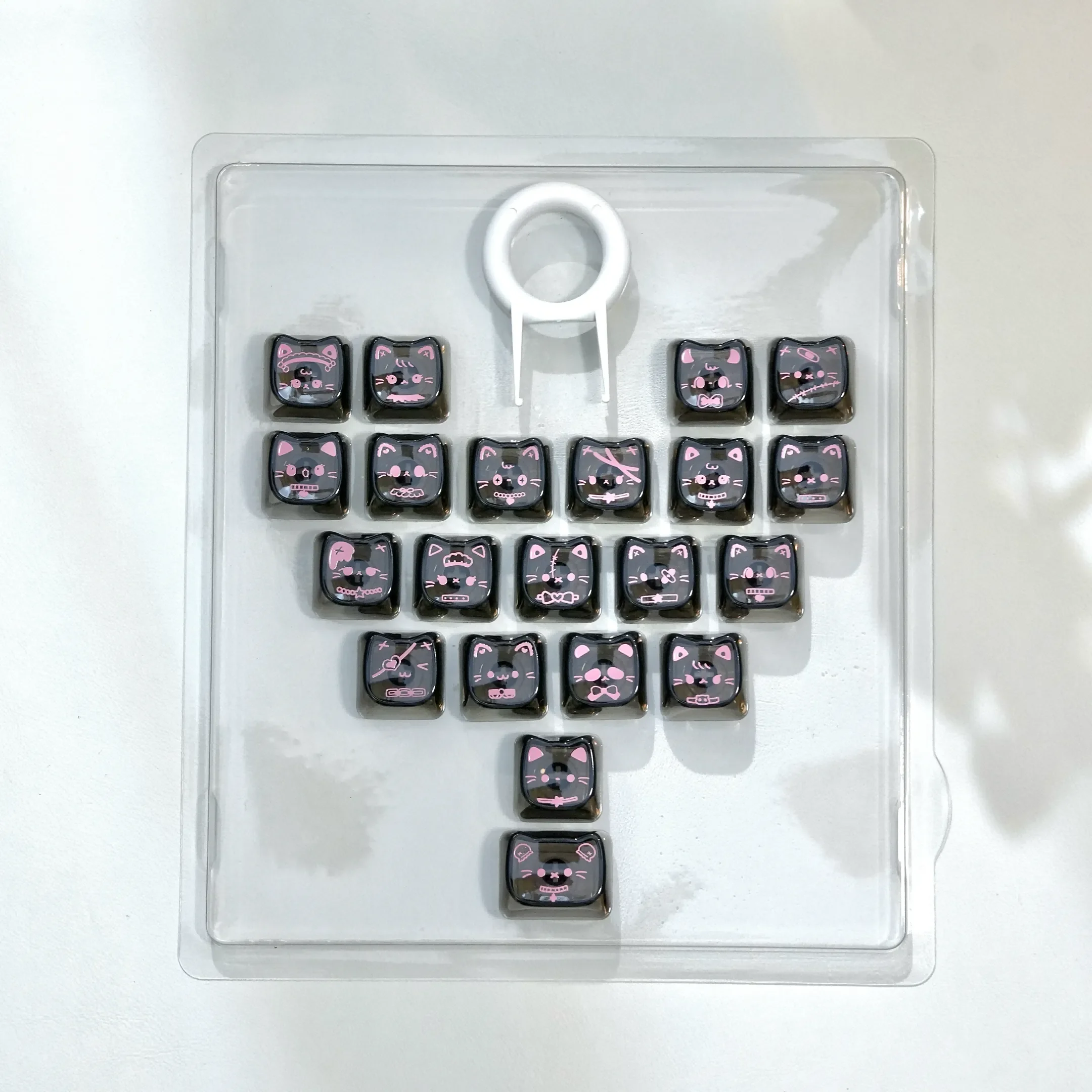 Playful pink transparent heart keycap set featuring adorable MAO cats, showcasing the unique and whimsical desktop aesthetic.