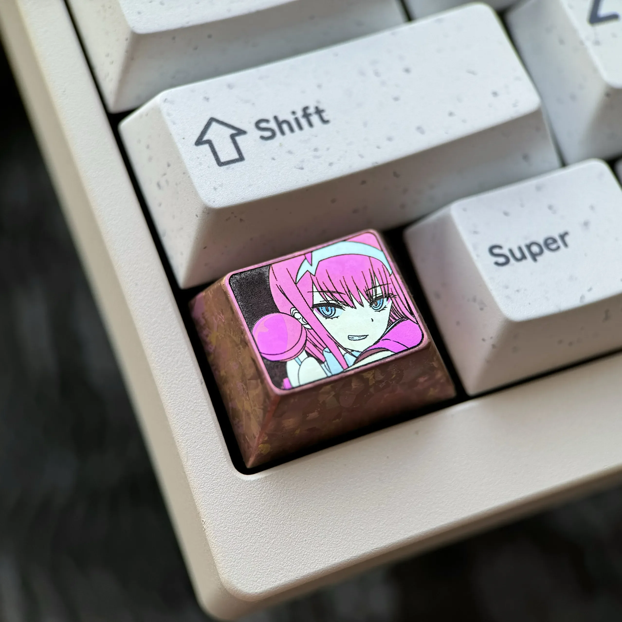 Close-up of an artisan Zero Two Titanium Keycap, highlighting its premium titanium alloy and vivid metallic finish as a custom Ctrl key.