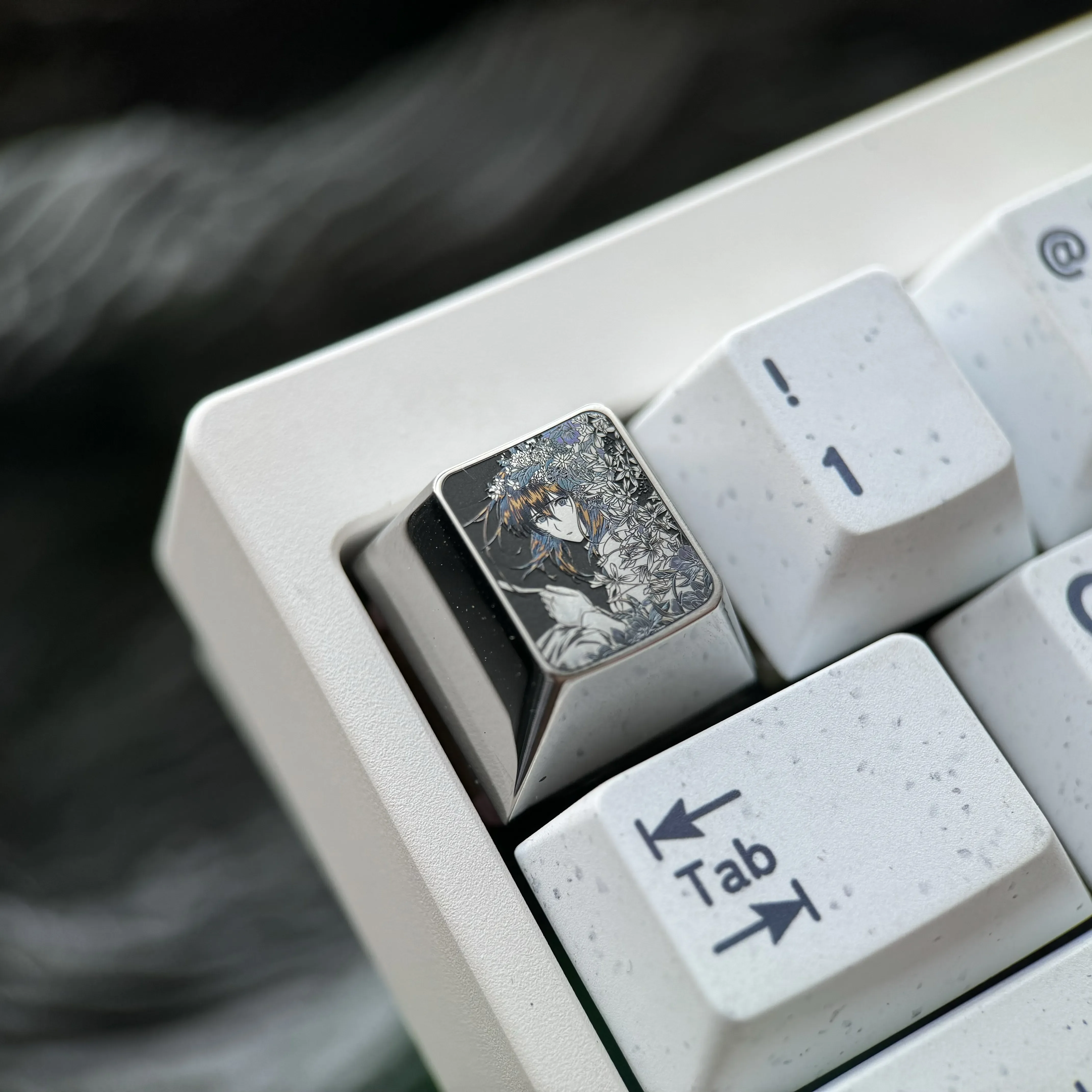 Multiple angles of the precision hand-carved titanium Violet Evergarden keycap. Reveals intricate artisan details and a lustrous finish, a unique design.