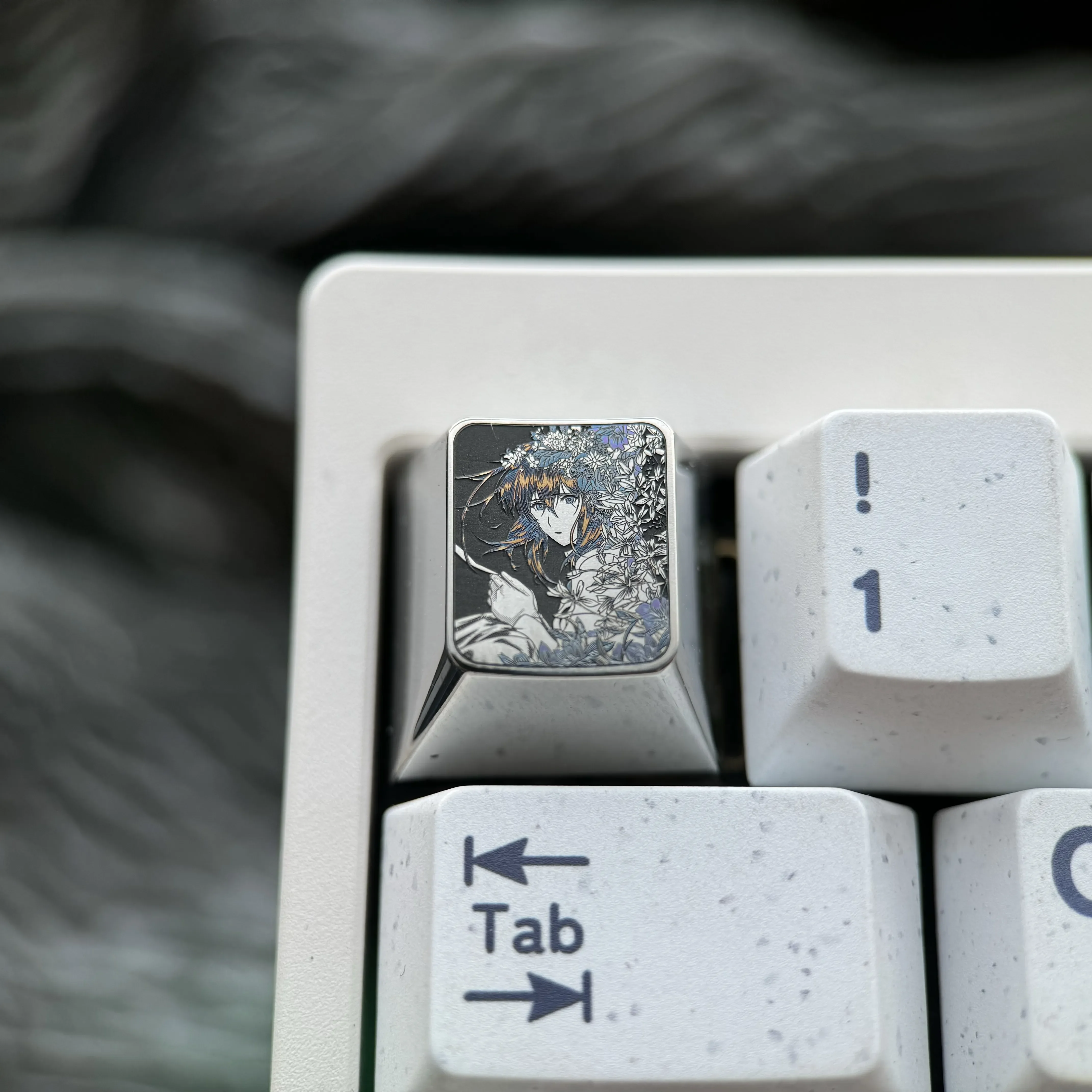 Main image of an exquisite hand-carved titanium Violet Evergarden keycap, highlighting intricate anime art and a lustrous, premium finish.