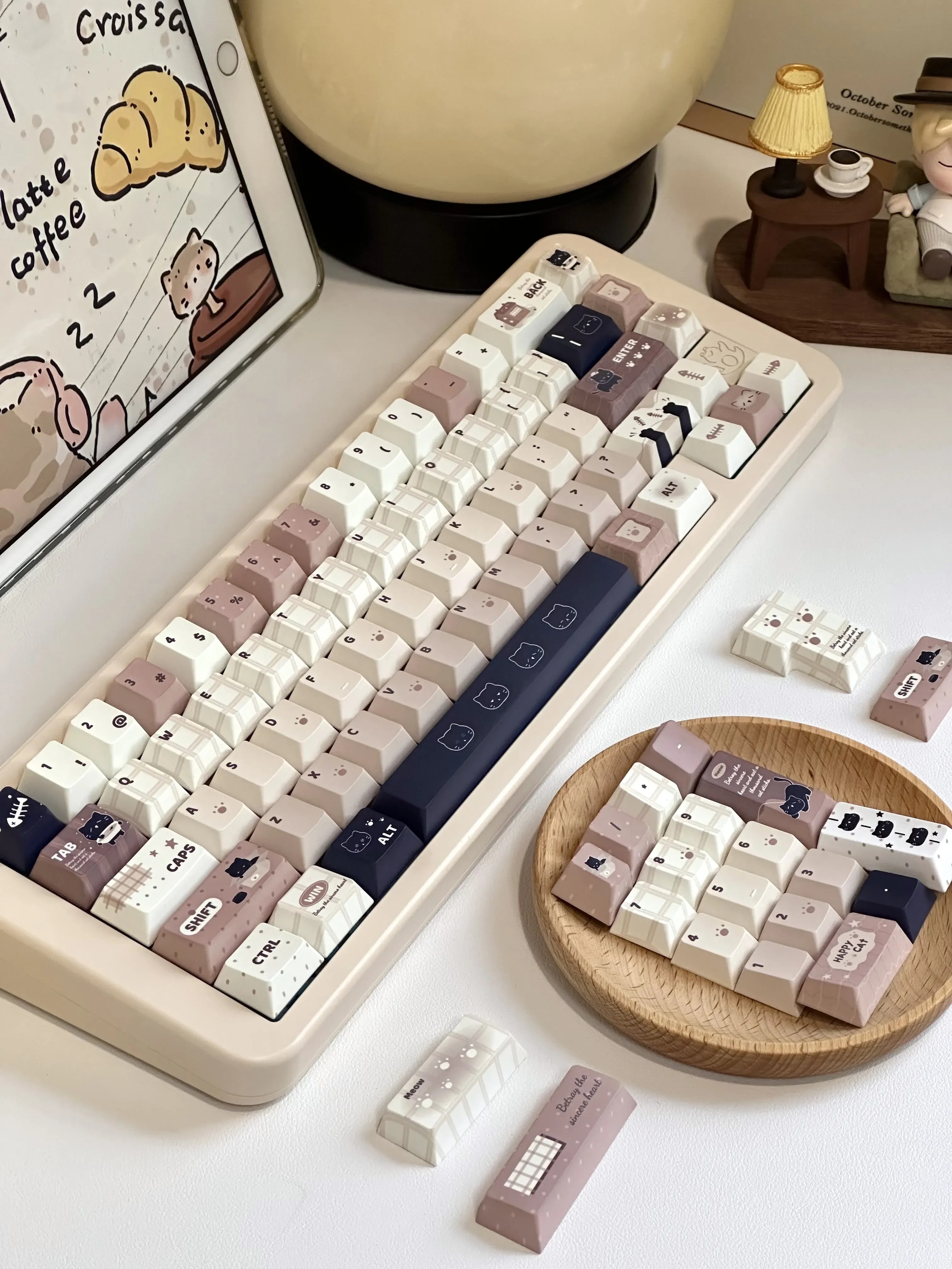 Whimsical cat keycaps set for mechanical keyboards, featuring adorable pastel illustrations of playful felines for charming personalization.