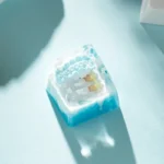 A collection of detailed views of the whimsical artisan Ice World Keycap, revealing the handcrafted resin miniature ice world diorama.