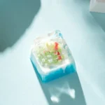 Close-up view of the whimsical handcrafted artisan Ice World Keycap, revealing the intricate miniature ice world diorama crafted from transparent resin.
