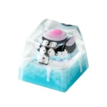 Whimsical handcrafted resin Ice World keycap showcasing a cute cartoon penguin in a vibrant miniature ice world diorama. Artistic keyboard charm.